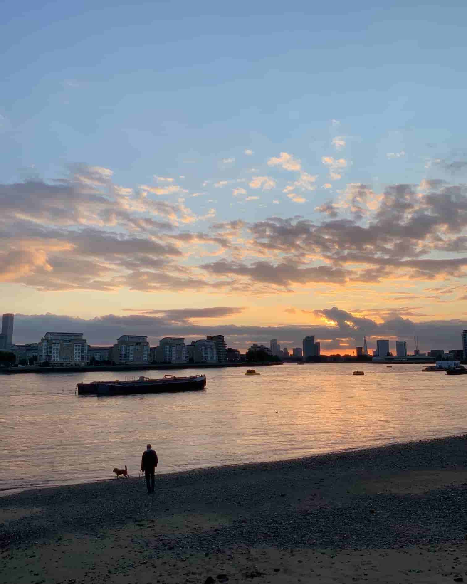 A picture of me and my dog Jimmy walking on the banks of river Thames.
