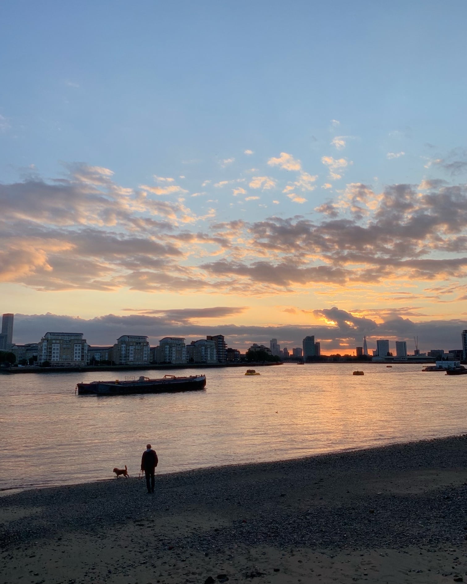 A picture of me and my dog Jimmy walking on the banks of river Thames.